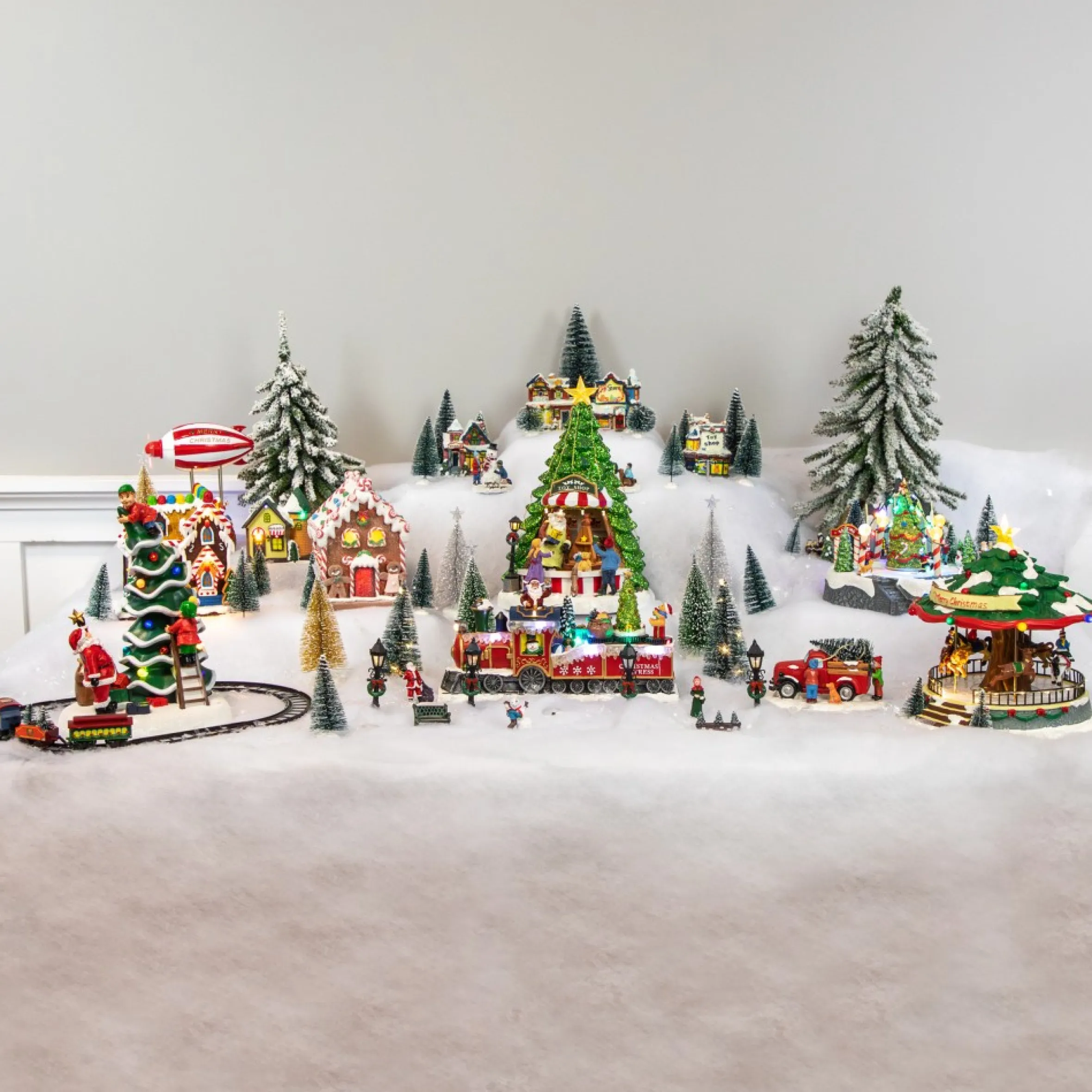 7-Piece Christmas Village Figurine And Tree Display Set